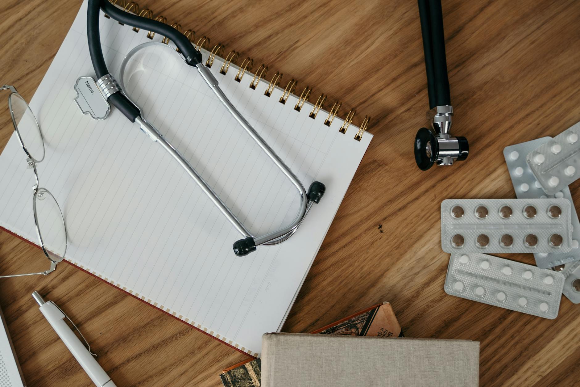 stethoscope and notebook on desk